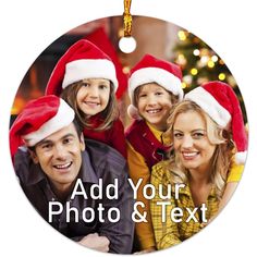 a christmas ornament with three people wearing santa hats and smiling for the camera