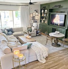 a living room filled with furniture and a flat screen tv on top of a wall