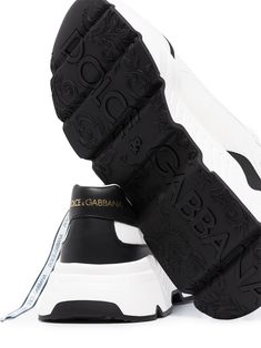 The humble 'chunky dad sneaker' gets a sleek update by Dolce & Gabbana. These two-tone Daymaster pair are set on a chunky rubber sole that is every bit as comfortable as it looks. The 80s called, they want them back. Featuring a two-tone design, a rubber sole and a front lace-up detail and a contrasting mirrored heel. | Dolce & Gabbana Daymaster two-tone sneakers Leather Chunky Sneakers With Logo Print And Round Toe, Leather Chunky Sneakers With Logo Print, Chunky Leather Sneakers With Logo Print, Luxury High-top Chunky Sneakers For Streetwear, Luxury Leather Platform Sneakers With Logo Print, Luxury Leather Logo Print Platform Sneakers, Luxury High-top Chunky Sneakers With Rubber Sole, Luxury Low-top Sneakers With Lug Sole, Luxury Chunky Sneakers With Contrast Sole