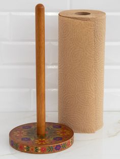 a wooden toilet brush and paper towel holder