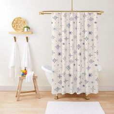 a bathroom with a white rug and shower curtain in the shape of animals on it