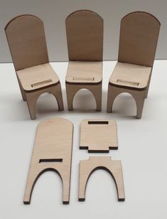 four wooden chairs and one chair cut out to look like they are made from wood