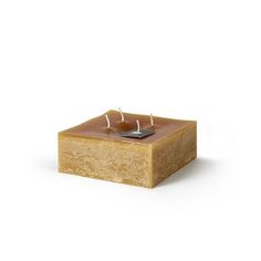 a square candle holder with two candles in it