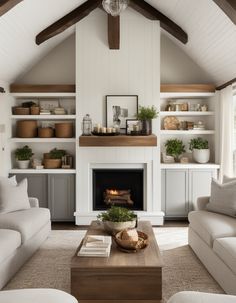 a living room with two couches and a fire place in it's center