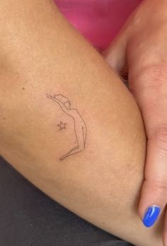 a woman's arm with a small tattoo on the left side of her leg