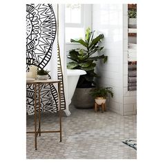 the bathroom is decorated with black and white designs on the walls, along with potted plants