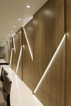 an empty conference room with wooden walls and chairs