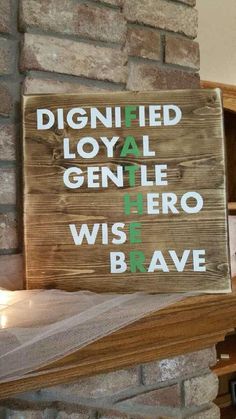 a wooden sign that says dignified royal gentle hero wise brave on the side of a brick wall