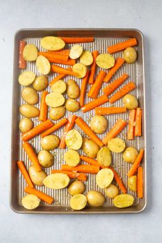 carrots and potatoes on a baking sheet