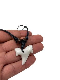 This is a Resin Shark Tooth. The necklace is very light and is adjustable can be used as a choker or as a long Necklace SYMBOL OF PROTECTION: Shark teeth have been recognized as a symbol of protection. The ancient Hawaiians wore shark tooth jewelry to keep any sea dangers at bay. Many surfers wear shark tooth necklaces to prevent sharks from attacking you and protect them while they are at sea. Nowadays, The charms and talismans are to bring shark tooth for good luck and safe for journey. Visit White Necklace With Adjustable Length, White Necklace With Adjustable Length For Gifting, White Necklace With Adjustable Length For Gift, White Adjustable Cord Jewelry Gift, White Adjustable Cord Jewelry For Gifts, Casual Necklace With Adjustable Length For Gift, Hawaiian Wear, Shark Teeth Jewelry, Shark Jewelry