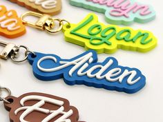 four keychains with the name alden written in different colors and letters on them