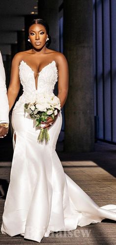 the bride and groom are walking down the aisle holding each other's hands as they walk towards the camera