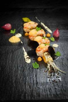 a black table topped with lots of food and utensils on top of it