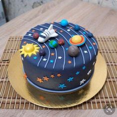 a space themed birthday cake on a table