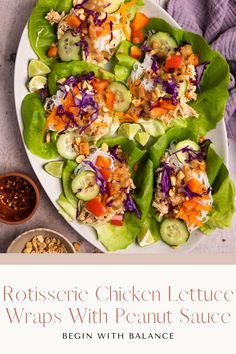 a white plate topped with lettuce wraps covered in toppings next to a bowl of sauce