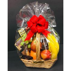 a basket filled with assorted fruits and chocolates on top of a black table