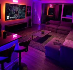 a living room filled with furniture and purple lighting