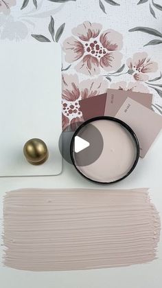 the paint swatches are being used to create a floral wallpaper design with pink flowers and gold accents