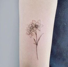 a single flower tattoo on the arm