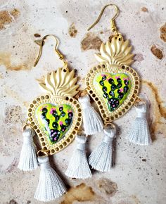 Detailed and beautiful artistically painted earrings, they are painted in detail carrying a small miniature painting of a cactus in multicolored tones, on each of the earrings, adorned with tassels, and are protected with several layers of jewelry varnish, improving the quality and durability of the earrings. These earrings are inspired by our Mexican culture and hand painted; They are the ideal gift because they combine with any outfit both day and night, enhancing the beauty of any woman and attracting attention for being unique handcrafted pieces, the Ideal gift for Mother's Day, holidays or for that special person.  Features/ Product info Note: Each earring is hand painted, there are small differences between each pair, so each pair of earrings in this store is unique. -The Main Materi Traditional Mexican Earrings, Unique Hand Painted Heart Earrings, Mexican Heart Earrings, Sacred Heart Dangle Earrings, Bohemian Multicolor Heart-shaped Earrings, Mexican Earrings, Painted Earrings, Mexican Culture, How To Apply Makeup