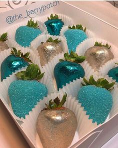 there are many strawberries in the box with blue and silver decorations on them,