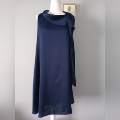 Look Fabulous In This Beautiful Navy Blue Signature By Robbie Bee Dress, Perfect For All Occasions. The Dress Features An A-Line Blouson Style With A Midi Length, Sleeveless Design, And Pull On Closure. The Neckline Is Unique And Can Be Seen In The Pictures, Making This Dress A Statement Piece. Brand Signature By Robbie Bee Color Navy Blue Sleeveless Size 14 Polyester And Lining Style Fit And Flare Brand New With Tags Shoulder To Down 38 Inch Armpit To Armpit 21 Inch Pull On Customer Label B6 Navy Sleeveless Midi Dress For Party, Navy Sleeveless Midi Party Dress, Chic Blue Sleeveless Pleated Dress, Chic Navy Sleeveless Midi Dress, Chic Blue Sleeveless Maxi Dress, Elegant Navy Sleeveless Mini Dress, Pink And Grey Dress, Blue Plus Size Dresses, Embroidered Summer Dress