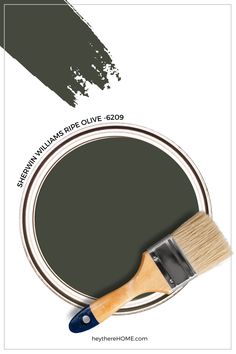 a paint can with a brush on top of it