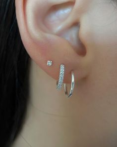 a close up of a person's ear with two different types of piercings