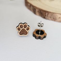 These beautiful wooden dog paw print stud earrings are meant for every dog lover and animal person alike. Best of all, they are also hypoallergenic, lightweight, and great for everyday wear! Each pair of earrings is laser cut in-house using sustainable American hardwood and sealed with a hypoallergenic shellac topcoat. Earrings are finished with hypoallergenic stainless steel posts. Material: sustainable American hardwood Sizing: 0.6 inch L x 0.5 inch W Laser Dog Ideas, Wood Laser Earrings, Wooden Earrings Laser Cut, Wooden Earrings Studs, Laser Earrings, Laser Jewelry, Laser Engraved Earrings, Wood Stud Earrings, Wood Jewelery