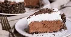 there is a piece of chocolate cake on the plate with whipped cream and chocolate shavings