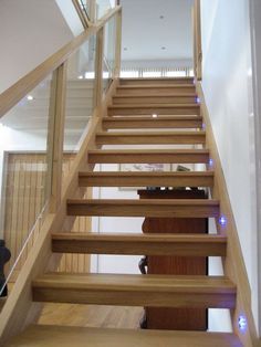 the stairs are made of wood and have glass balconies