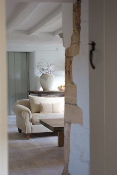 an open door leading to a living room with a couch and coffee table in it