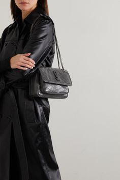 SAINT LAURENT's 'Niki Baby' bag is purposefully crinkled and crackled to look like a vintage find. Made in Italy from glossed-leather, it has a sliding chain strap, so you can alter the drop and is topped with a tonal logo plaque. Despite its mini size, the compartmented interior will easily hold your cell phone, cardholder and compact. Ysl Niki Bag Outfit, Ysl Niki Bag, Chain Bag Outfit, Mini Bag Outfit, Shoulder Bag Outfit, Purse Outfit, Luxury Purses, Mini Quilt, Saint Laurent Bag