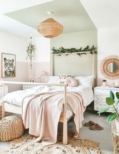 a bedroom with pink walls and white bedding, wicker baskets on the floor