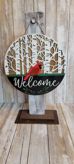 a welcome sign with a cardinal on it