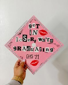 someone is holding up a pink graduation cap with the words get in, i see we are graduating