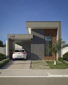 a car is parked in front of a modern house with an entry way and driveway