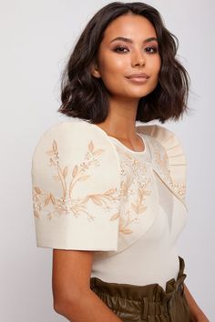 You can never go wrong with beige. Mestizo has crafted the Lily Bolero in this color with versatility and practicality in mind. The piece suits a range of skin tones and works well with a variety of colors. Whether you are going for that toned down minimalist look or a daring ensemble, the Lily Bolero has got you covered. Features: Beige (Cocoon) Classic beige color with two-tone beige embroidery for a tonal aesthetic that's undeniably chic. This Lily Bolero is part of Mestizo's Vintage Edition Filipino Bolero Outfit, Modern Filipiniana Hairstyle, Hairstyle For Filipiniana Attire, Filipino Embroidery, Filipino Dress