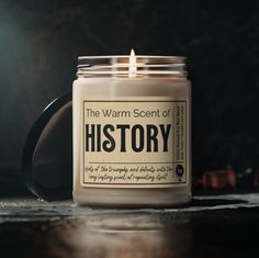 a candle that is sitting on a table next to a black mug with the words after half marathon glow