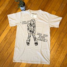 a white t - shirt with an image of a woman wearing roller skates and text that reads, did you even care?