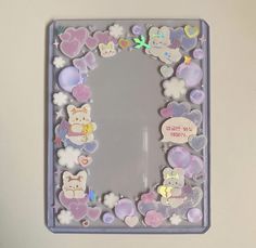 a mirror that has some stickers on the side of it with hello kitty and other things around it