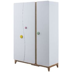 a white cabinet with two doors and three balls on it