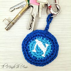 there is a crocheted keychain with several keys on it