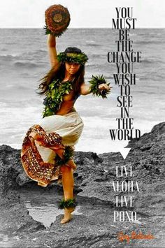 a woman in a hula skirt is dancing on the rocks with her hand up