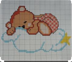 a cross stitch teddy bear laying on top of a cloud