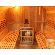 the inside of a wooden sauna with two benches and a heater in it