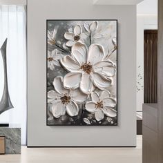 a large white flower painting in a living room