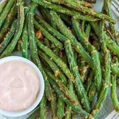 asparagus on a plate with dip in the middle