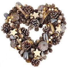 a heart shaped wreath with pine cones and other decorations