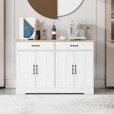 a white cabinet with two doors and a round mirror on the wall in a room